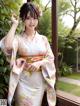 A woman in a kimono posing for a picture.