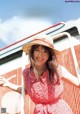 A woman in a red dress and a straw hat.