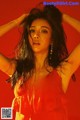 A woman in a red dress posing for a picture.